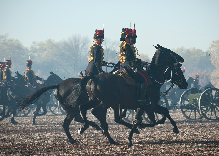 Mounted soldiers in ceremonial attire riding horses during a horse show performance Mounted soldiers in ceremonial attire riding horses during a horse show performance