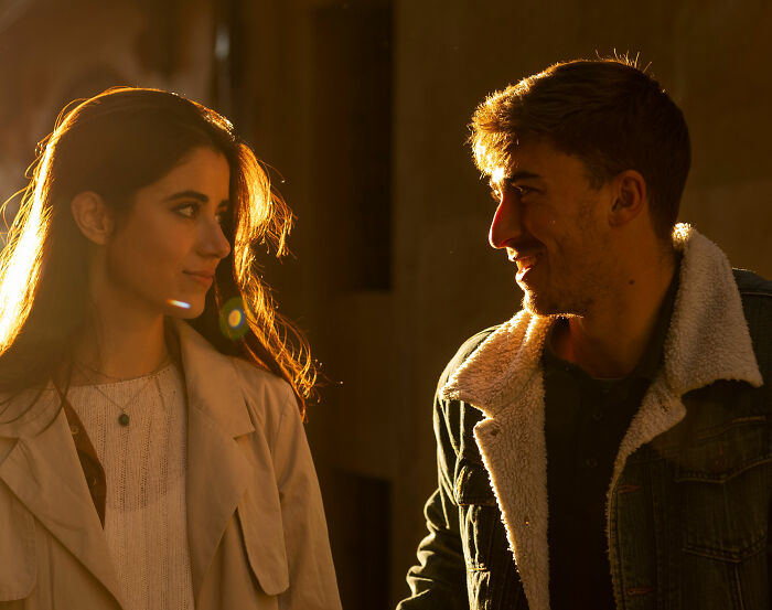 A couple on a first date looking at each other in golden hour light. The man is smiling, showing how some dates can be scary.