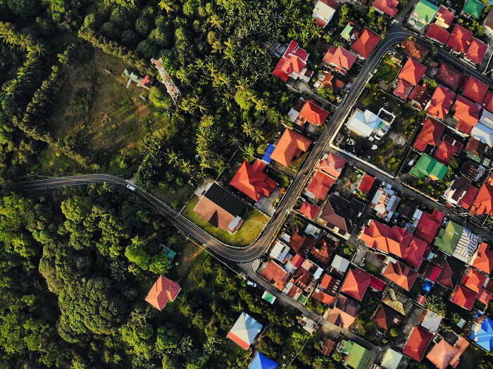 Aerial view of neighborhood with roads and houses, context for pizza delivery routes