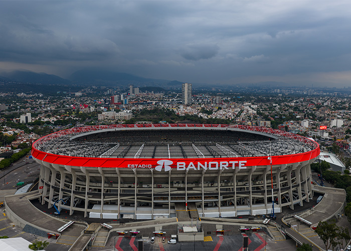 Aerial view of Estadio Banorte under cloudy skies, symbolizing the negative sentiment towards the World Cup hosts. Aerial view of Estadio Banorte under cloudy skies, symbolizing the negative sentiment towards the World Cup hosts.