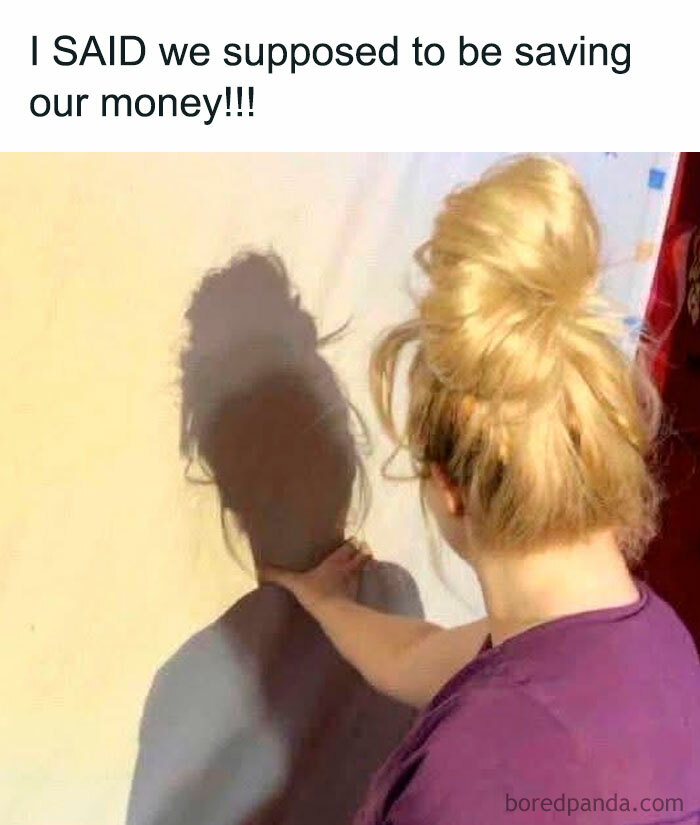 Woman pressing shadow of hands on wall with text about saving money