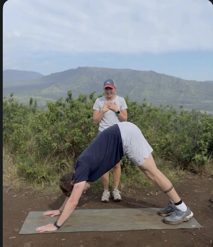 Woman reacts happily as a man does a yoga pose, hinting at a proposal pic, inspiring hilarious edits.