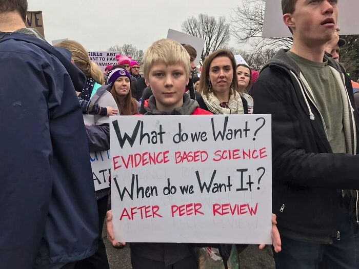 Protest sign demands evidence based science after peer review in science memes