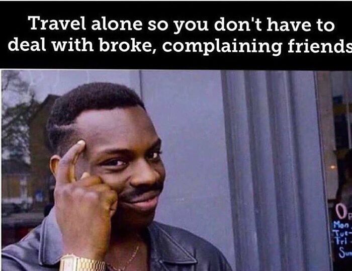 Travel memes image with a man tapping his head, suggesting solo travel to avoid broke friends.