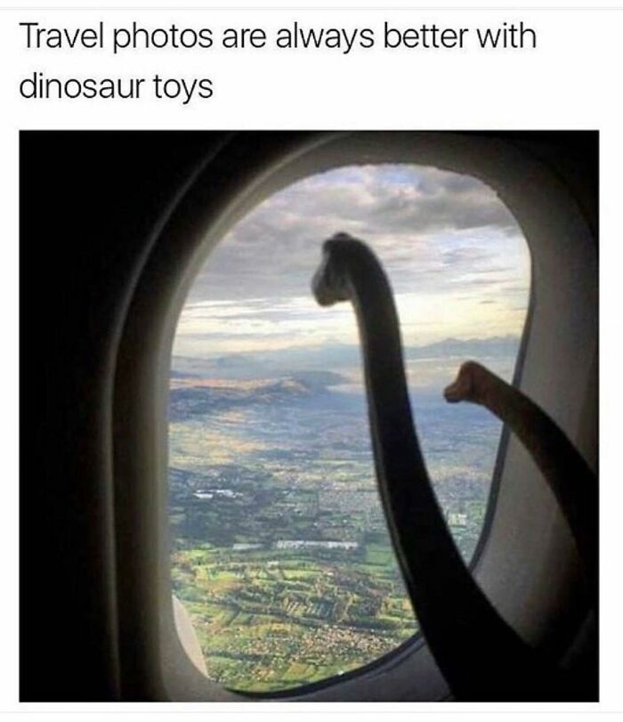 A funny travel meme featuring two dinosaur toys peeking out of an airplane window at a scenic landscape below.