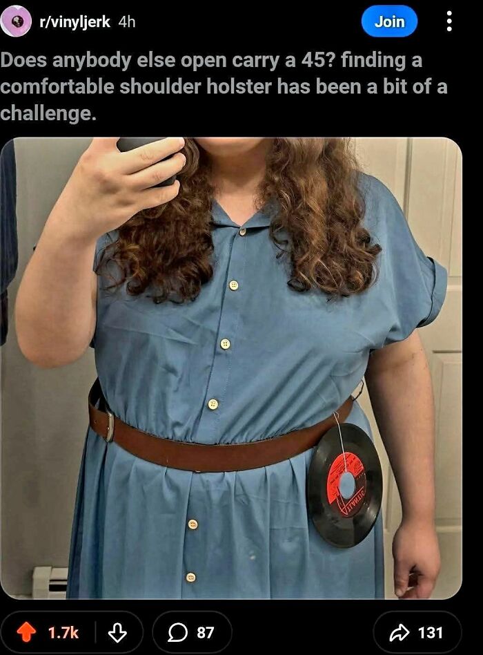 Person wearing dress with vinyl record attached to belt like a holster in a humorous internet chaos post