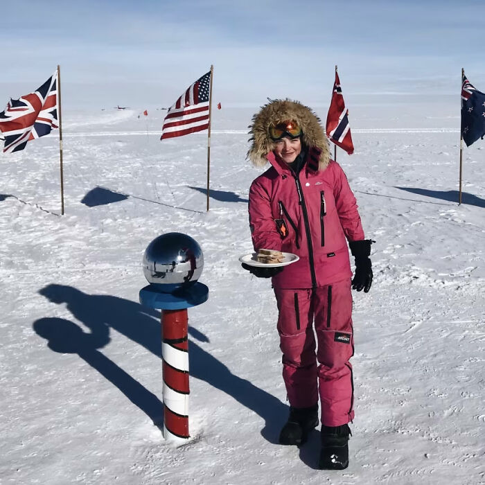 Person in winter gear holding sandwich plate in snowy field with flags, symbolizing sharp comeback
