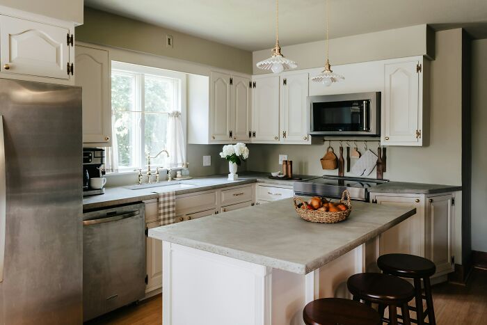 Bright modern kitchen with island and stools, natural light