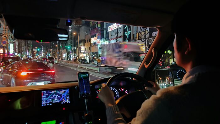 Night driving from inside a car with navigation on. Considering habits that save you money.