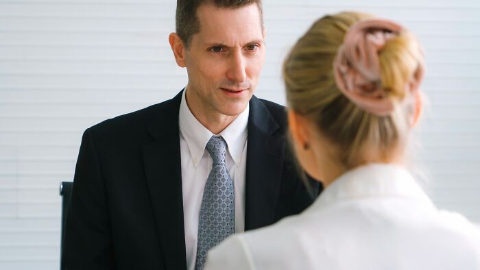 Two lawyers in a serious discussion, highlighting the challenges of defending hard cases.