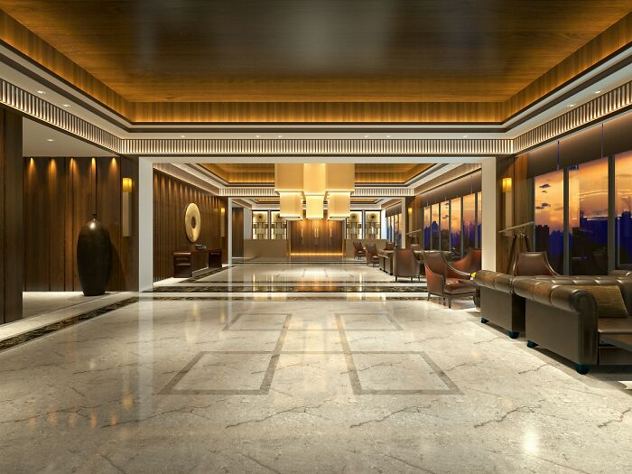 Luxury hotel lobby with modern lighting and seating area at sunset