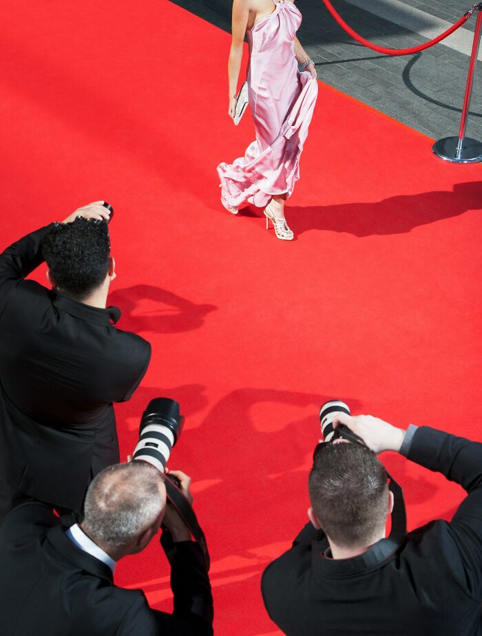 Photographers capturing woman on red carpet event