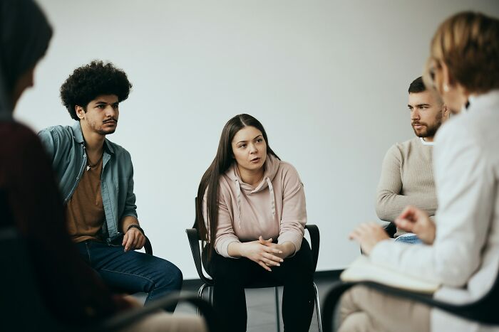 Group therapy session in psychiatric facility with diverse participants