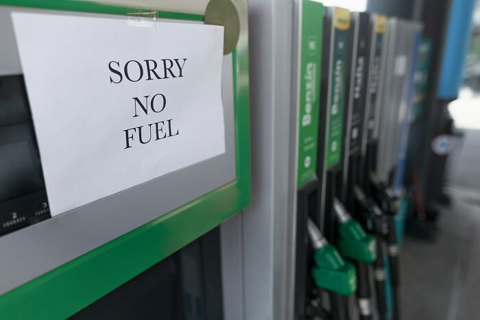 Gas station pump with sorry no fuel sign indicating fuel shortage
