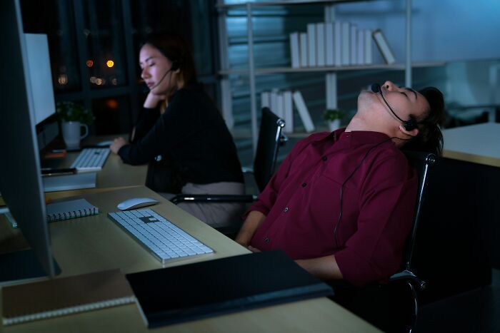 Tired call center employees stressed at night shift
