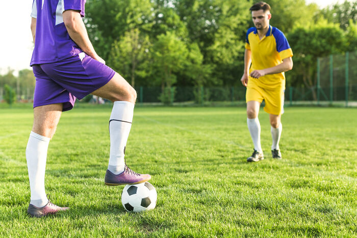 Soccer players on field preparing for match amid unexpected disaster
