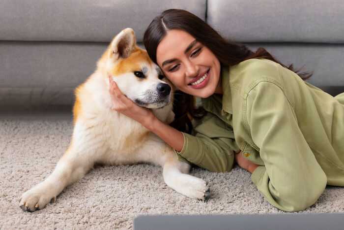 Woman cuddling dog preventing unexpected disaster