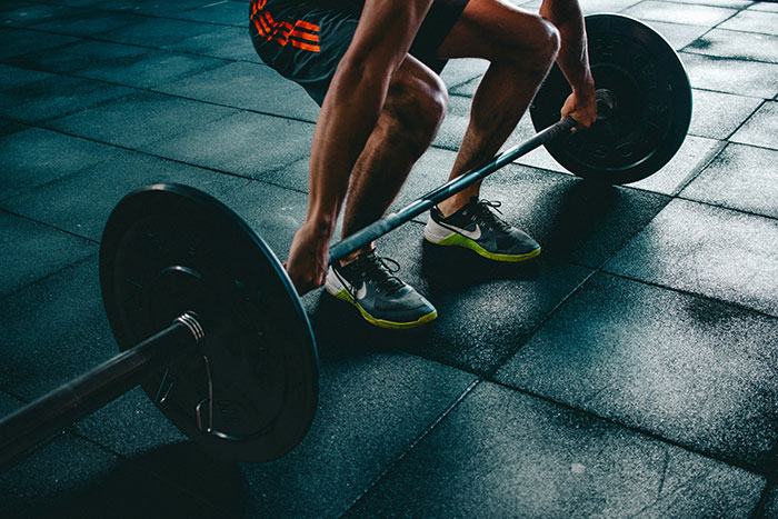 A person in athletic gear lifting weights, potentially demonstrating how active lifestyles can contribute to being biologically a year younger. A person in athletic gear lifting weights, potentially demonstrating how active lifestyles can contribute to being biologically a year younger.