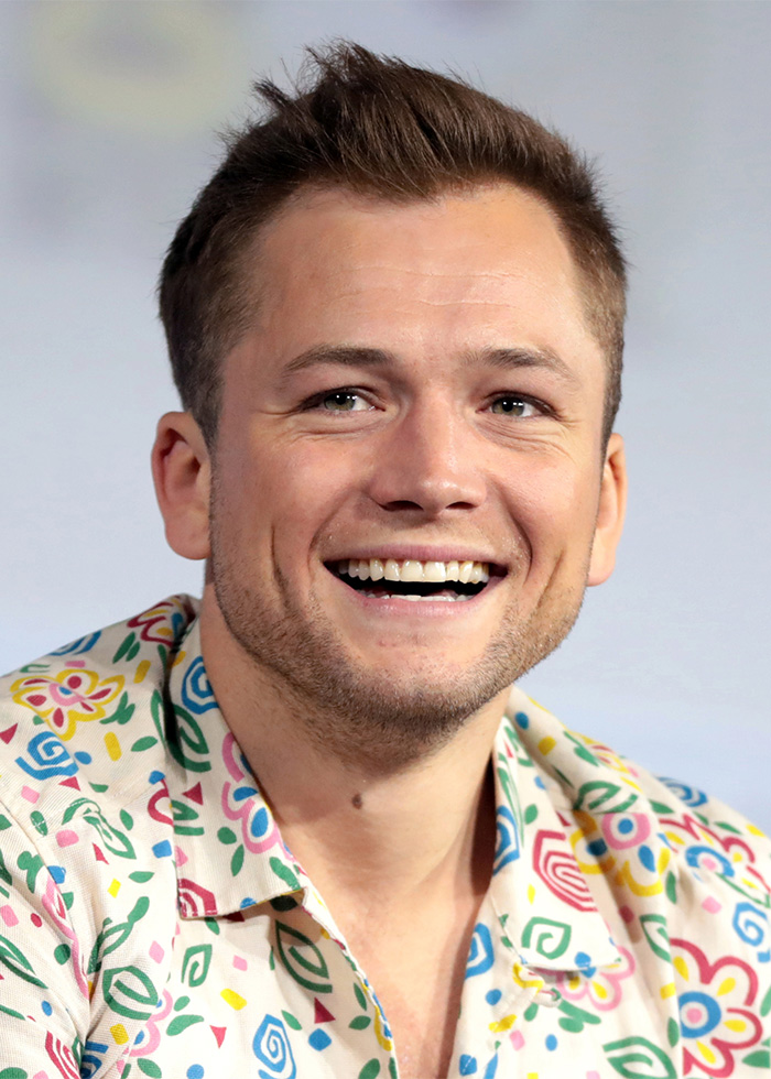 Smiling young man in colorful patterned shirt with short hair