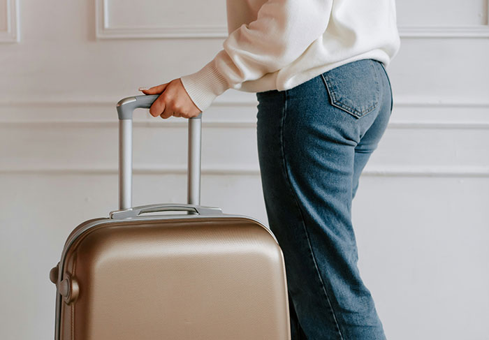 Person holding suitcase ready to leave rental property after tenant troubles