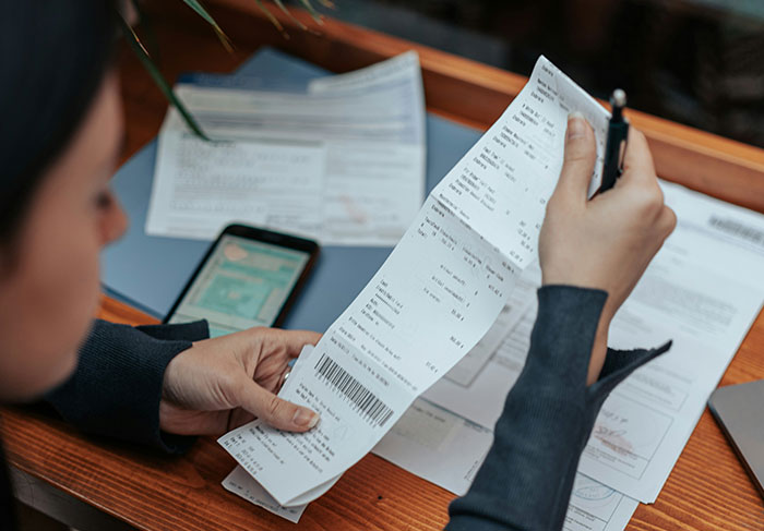 Tenant reviewing bills and receipts illustrating landlord tenant disputes