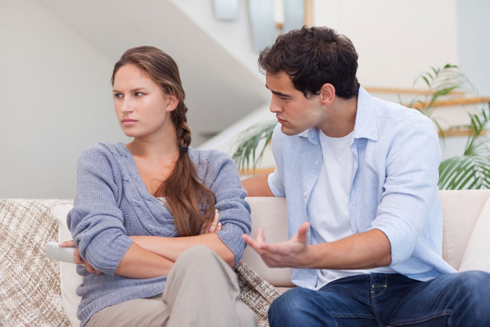 Couple having a tense conversation about cheating husband and mistress issues at home