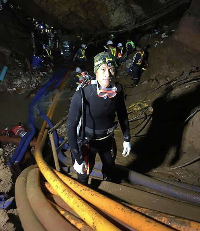 Diver in cave surrounded by rescue team in creepy photo