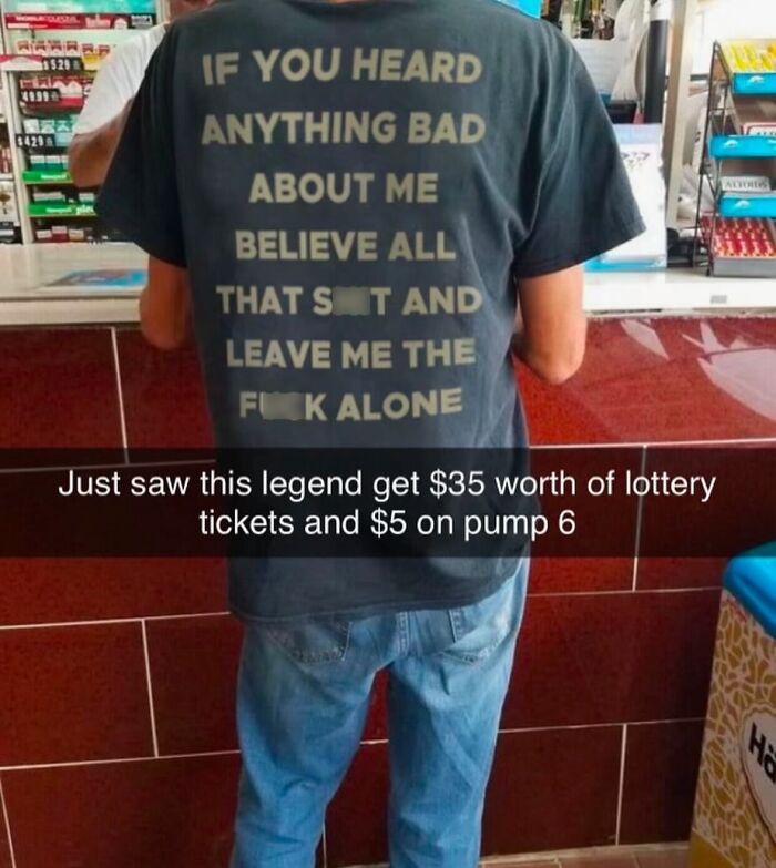 A man from behind, wearing a black T-shirt with the text If You Heard Anything Bad About Me Believe All That.