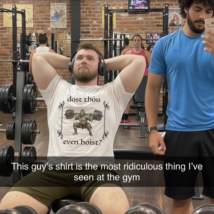 A man at the gym wearing a T-shirt that says Dost Thou Even Hoist, with a graphic of a warrior lifting weights.
