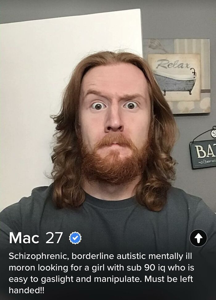 Dating profile selfie of man with long hair and beard with controversial description