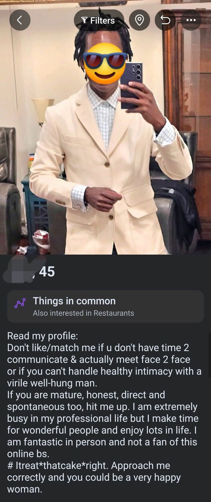 Man in beige blazer taking mirror selfie on dating app profile with market value caption