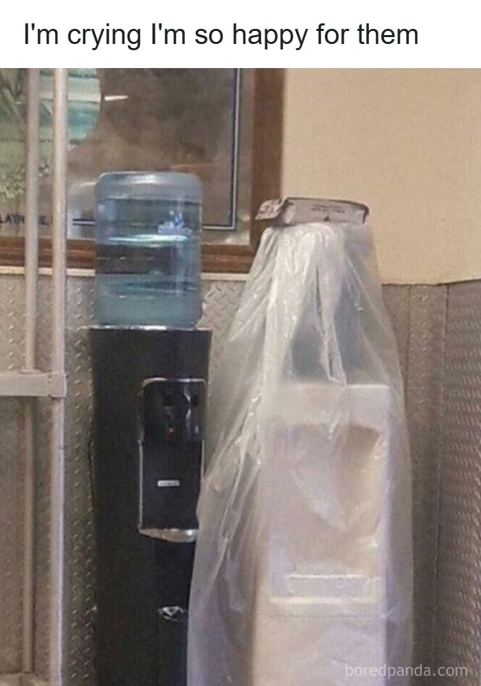 Water cooler next to wrapped object resembling a couple hugging pareidolia