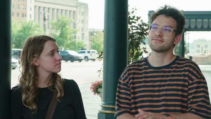 Young man and woman standing outdoors in thoughtful conversation about situationship
