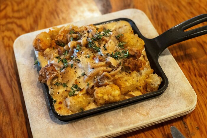 Baked tater tot casserole with cheese and herbs for poverty meals
