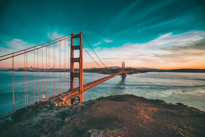 Golden Gate Bridge over water during sunset