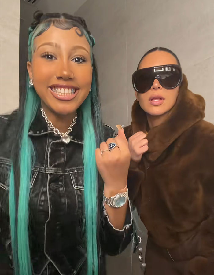 Two women posing indoors with trendy outfits Two women posing indoors with trendy outfits