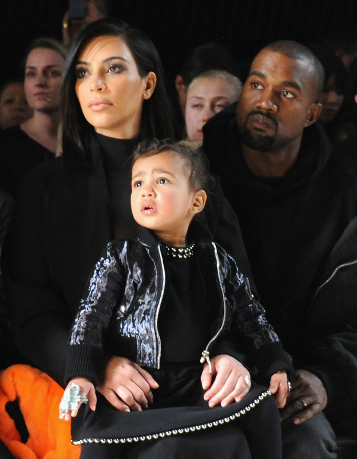 Kim Kardashian, North West and Kanye West seated together at a public event Kim Kardashian, North West and Kanye West seated together at a public event