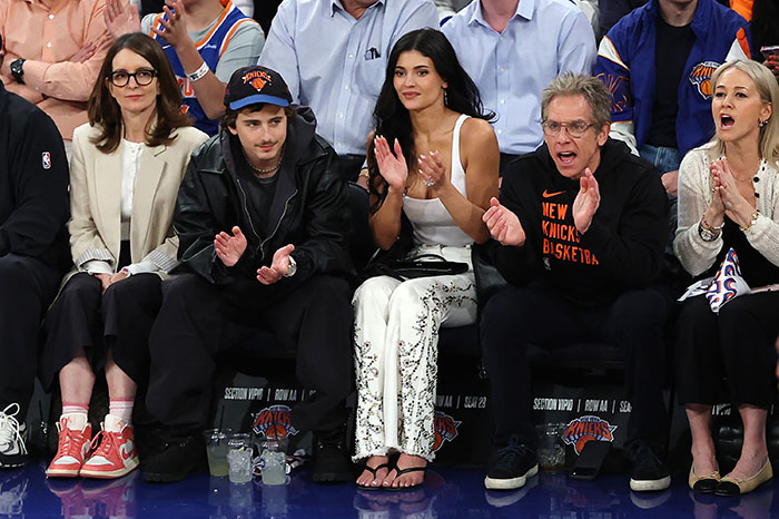 Tina Fey and Timoth&eacute;e Chalamet seated courtside at basketball game