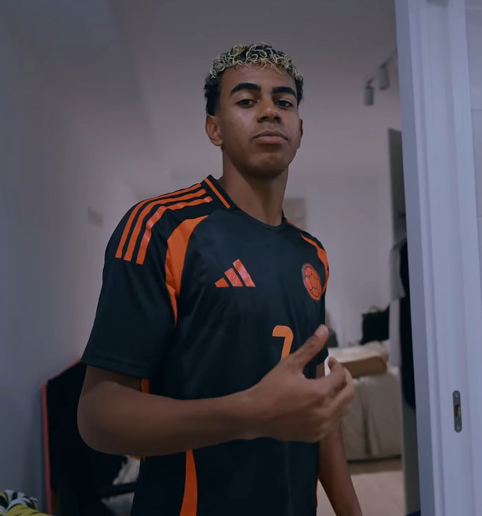 Young male athlete in black and orange soccer jersey Young male athlete in black and orange soccer jersey