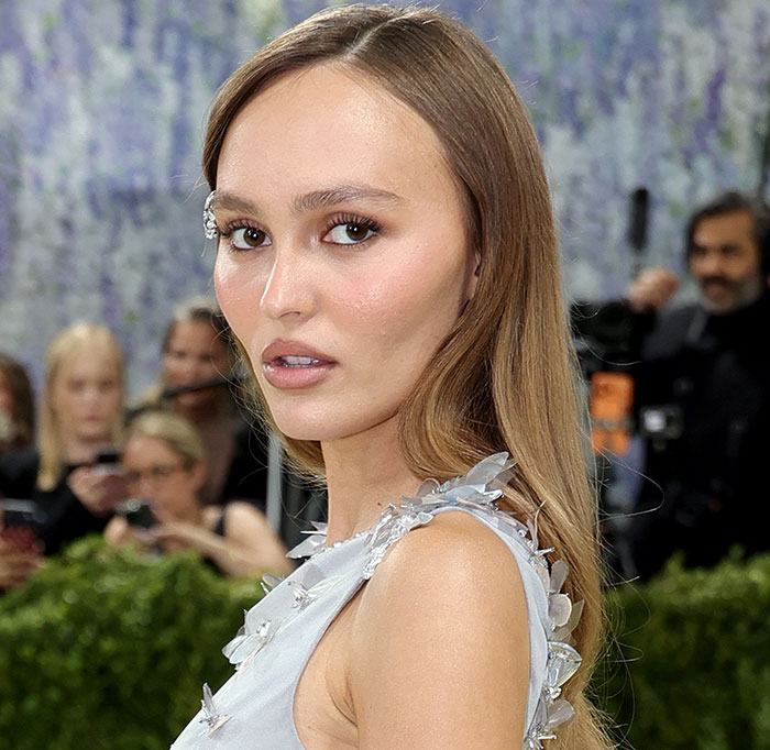 A woman with long brown hair looks at the camera. Her face shows features commonly associated with plastic surgery. Met Gala 2026.