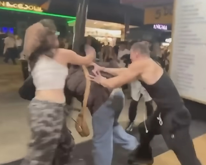 Looksmaxxer androgenic engaged in a physical fight with flight attendant in public area