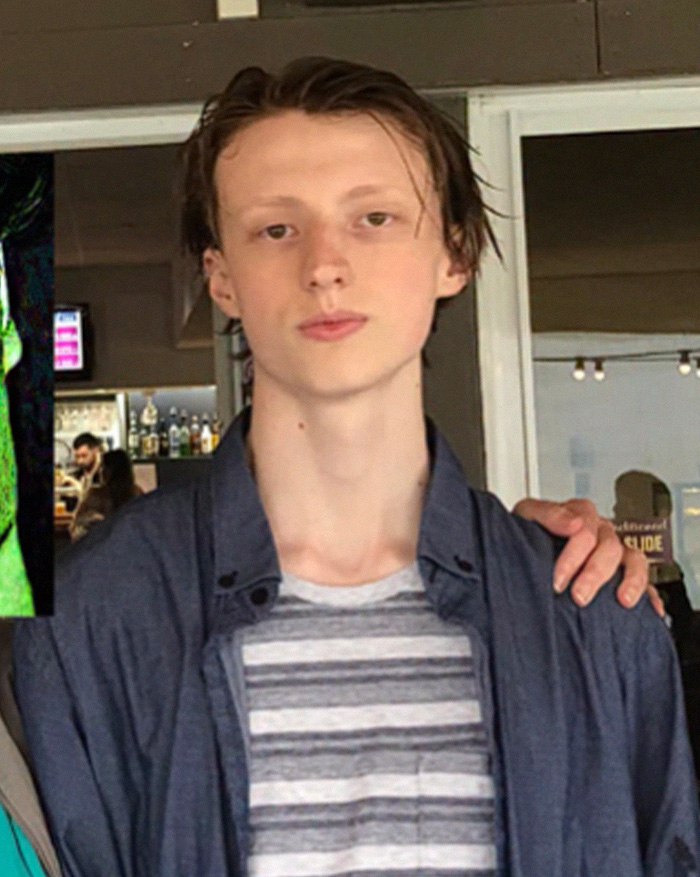 Portrait of young male looksmaxxer with wet hair and striped shirt