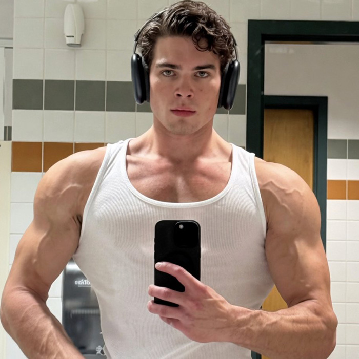 Selfie of looksmaxxing influencer showing muscular arms in tank top Selfie of looksmaxxing influencer showing muscular arms in tank top