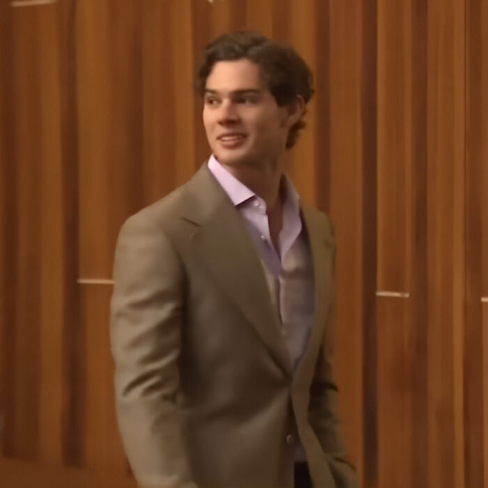 Well-dressed man smiling representing looksmaxxing transformation influencer Clavicular Well-dressed man smiling representing looksmaxxing transformation influencer Clavicular