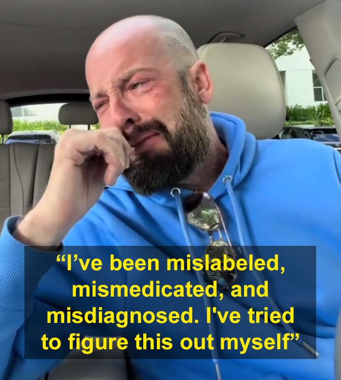 A crying man in a blue hoodie in his car, expressing how a diagnosis changes everything after feeling something is wrong.