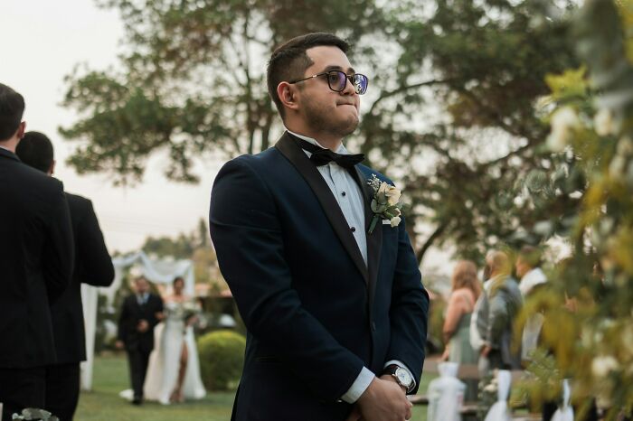 Groom in tuxedo waiting nervously at wedding venue