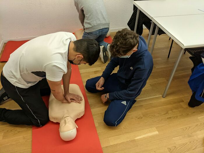 CPR training with a dummy, focusing on chest compressions. People learn skills that will stay with you in emergencies.