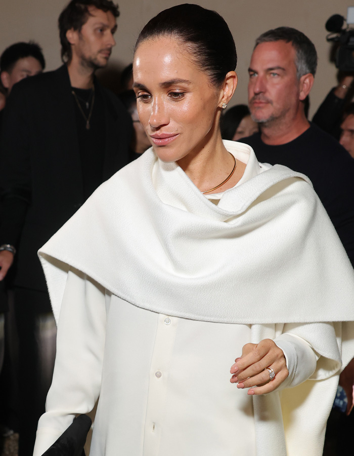 Meghan Markle dressed in white at a public event showcasing her changing appearance