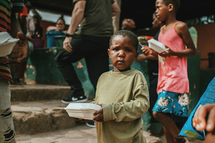 Child holding food container in crowded setting scary inevitable moments