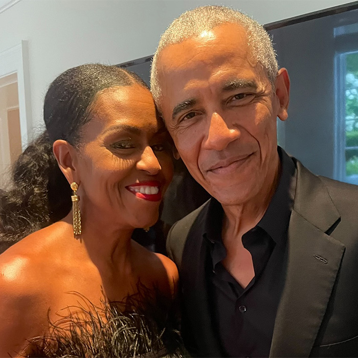 Michelle Obama and Barack Obama posing closely at event